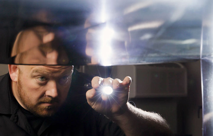 Stanley Steemer technician inspecting air ductwork