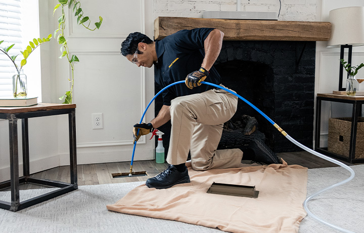 Stanley Steemer Technician Cleaning Air Ducts in Minneapolis, MN Home