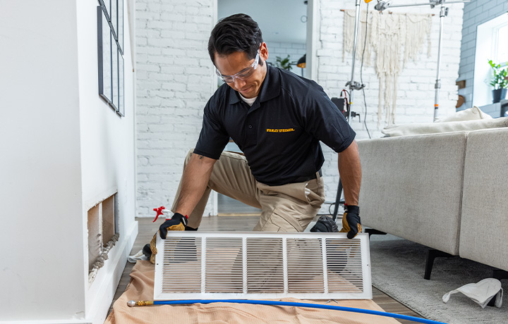 Stanley Steemer Cleaning Technician Inspecting Air Ducts in Minneapolis, MN Home