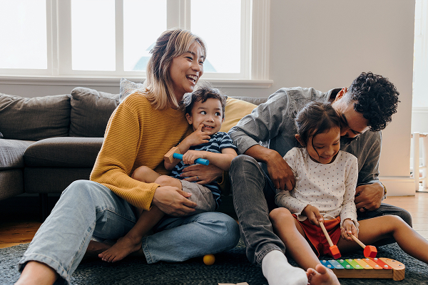 family in spring cleaned living room playing with kids