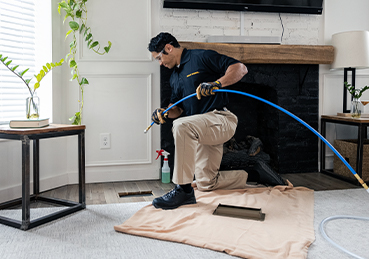 Technician Cleaning Air Ducts