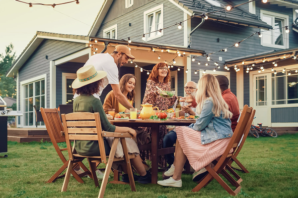 family in backyard outside eating dinner
